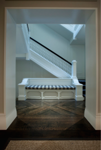 Dark stained white-oak chevron floor in the stair hall of a 1920s Chicago Gold Coast limestone mansion renovated by Michael Abrams Limited